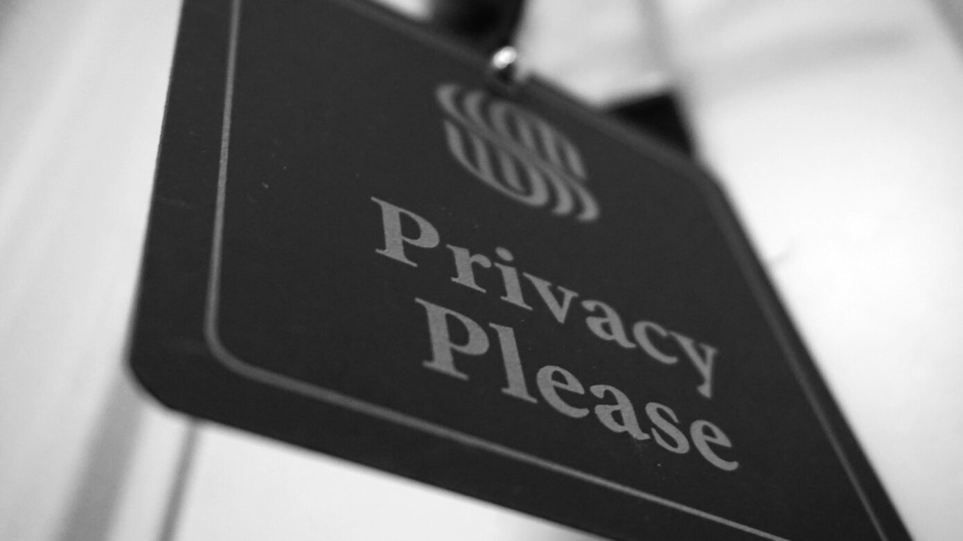 A black sign that says "Privacy Please"