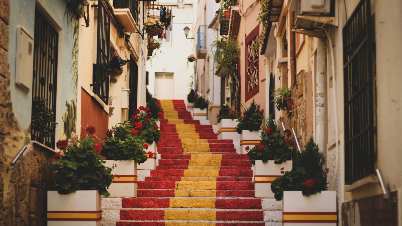 A staircase painted as the Spanish flag in an old town.
