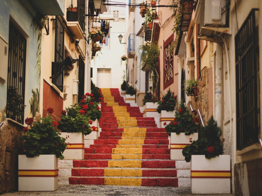 A staircase painted as the Spanish flag in an old town.